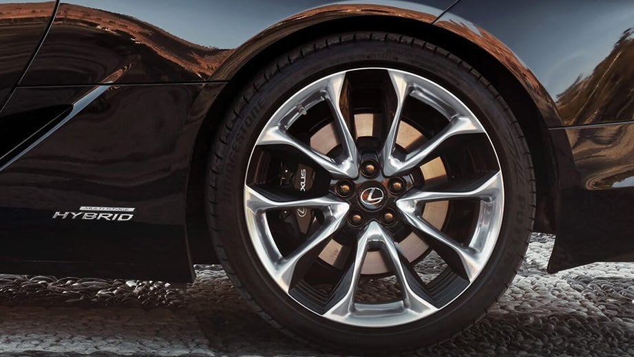 Close-up of the rear wheel and hybrid badge of a Lexus LC 500h