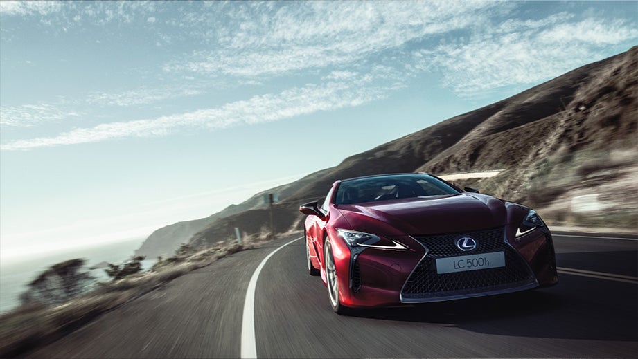 front view of a Lexus LC 500h driving on a mountain road