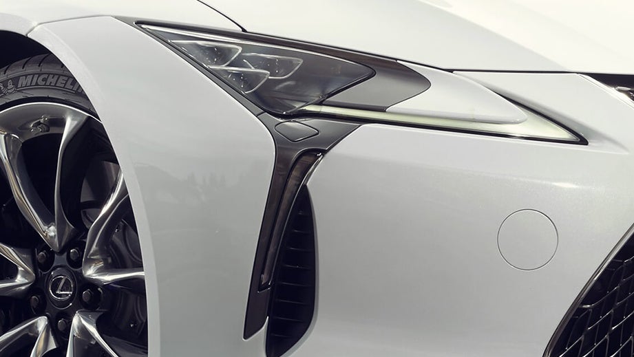 Front wheel and headlight close-up of a White Nova Glass Flake Lexus LC 500h