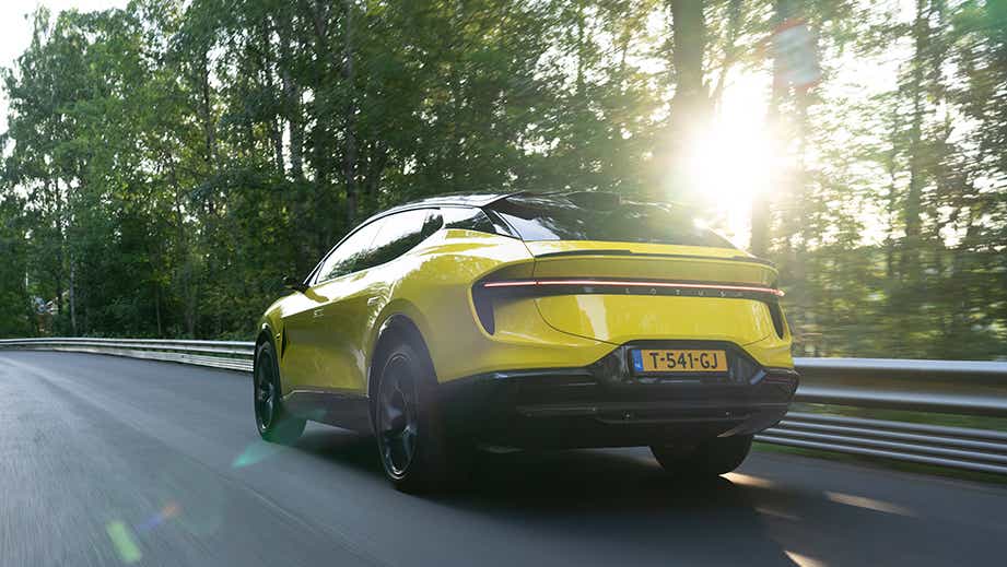 rear three-quarter of a Solar Yellow Lotus Eletre