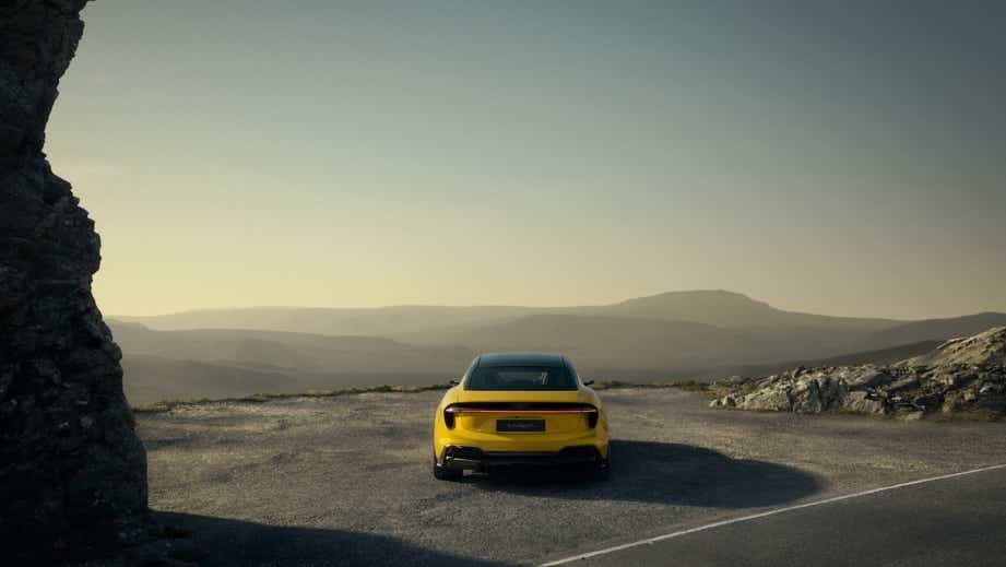 Rear view of a Lotus Emeya by a mountain road