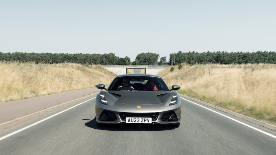 Front view of a Lotus Emira on a countryside road