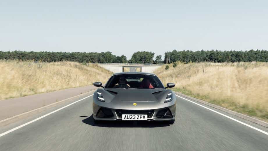 Front view of a Lotus Emira on a countryside road