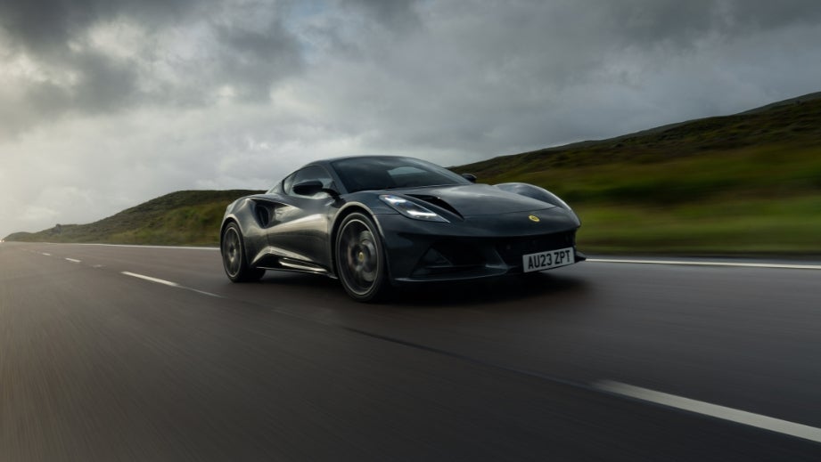 front three-quarter view of a Lotus Emira on an open road