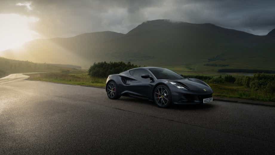 front three-quarter view of a Lotus Emira on a scenic road