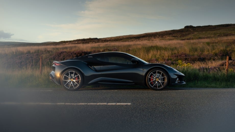 side view of a Lotus Emira on a country road
