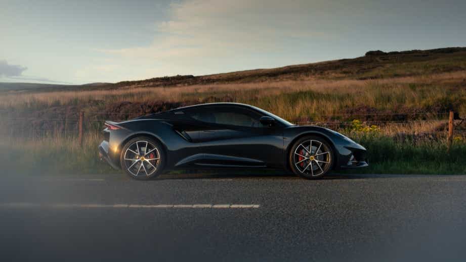 side view of a Lotus Emira on a country road