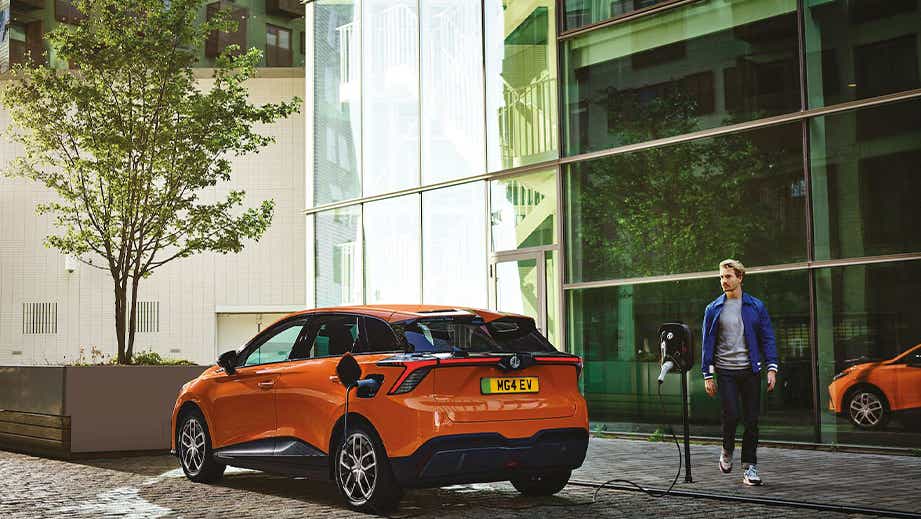 rear three-quarter of a MG 4 EV charging outdoors