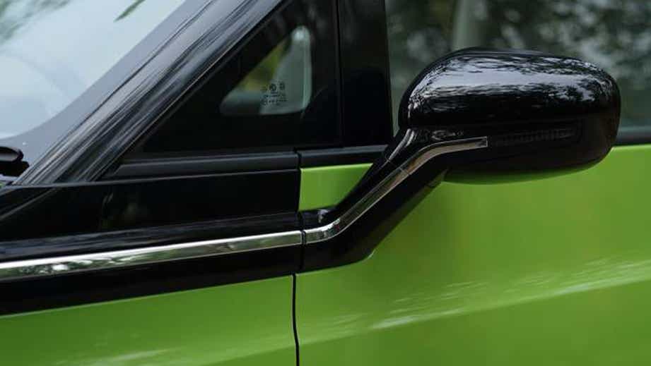 Side mirror close-up of a Apple Green With Starry Black MG Comet EV