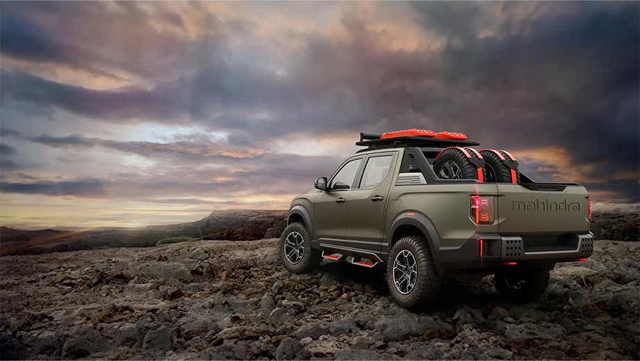 rear three-quarter view of a Mahindra Global Pik Up on rocky terrain