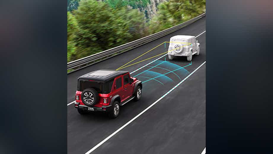 Rear three-quarter view of a Mahindra Thar ROXX on a highway