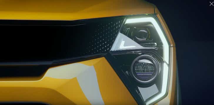 headlight close-up of a Citrine Yellow Mahindra XUV 3XO