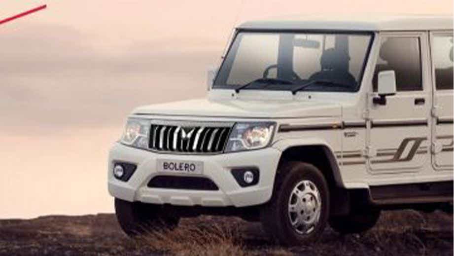 Front three-quarter view of a Diamond White Mahindra Bolero