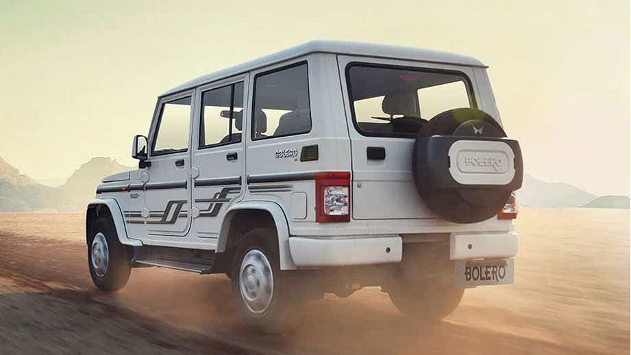 rear three-quarter of a Diamond White Mahindra Bolero