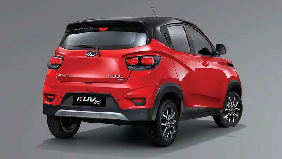 rear three-quarter of a Flamboyant Red With Metallic Black Mahindra KUV 100 NXT
