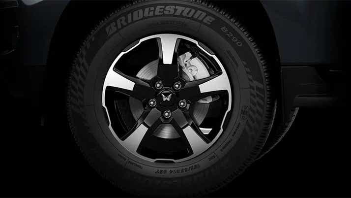 Front alloy wheel and tire of a Mahindra Scorpio Classic