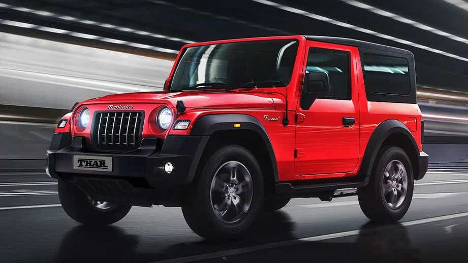 front three-quarter of a Rage Red Mahindra Thar