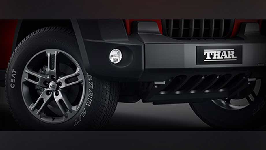 Front bumper and left wheel of a Mahindra Thar
