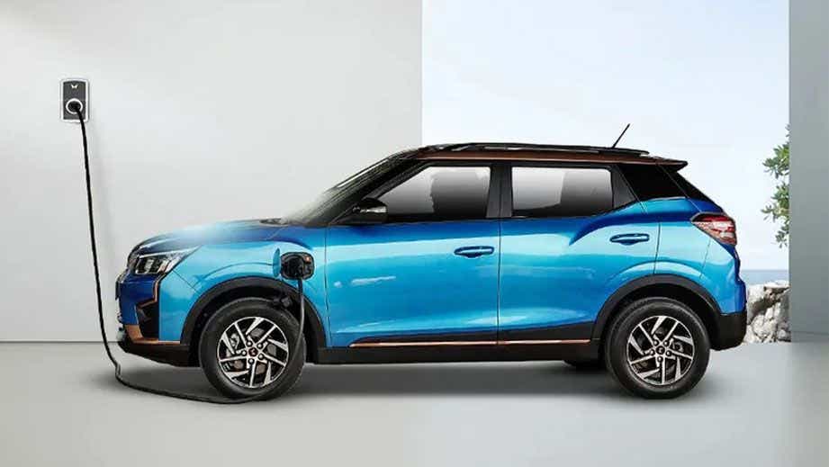 side view of a Infinity Blue Dualtone Mahindra XUV400 EV being charged
