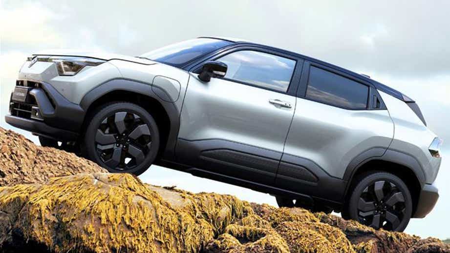 side view of a Splendid Silver with Bluish Black Roof Maruti Suzuki e Vitara