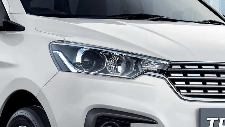 Front headlight and grille view of a Maruti Suzuki Ertiga Tour