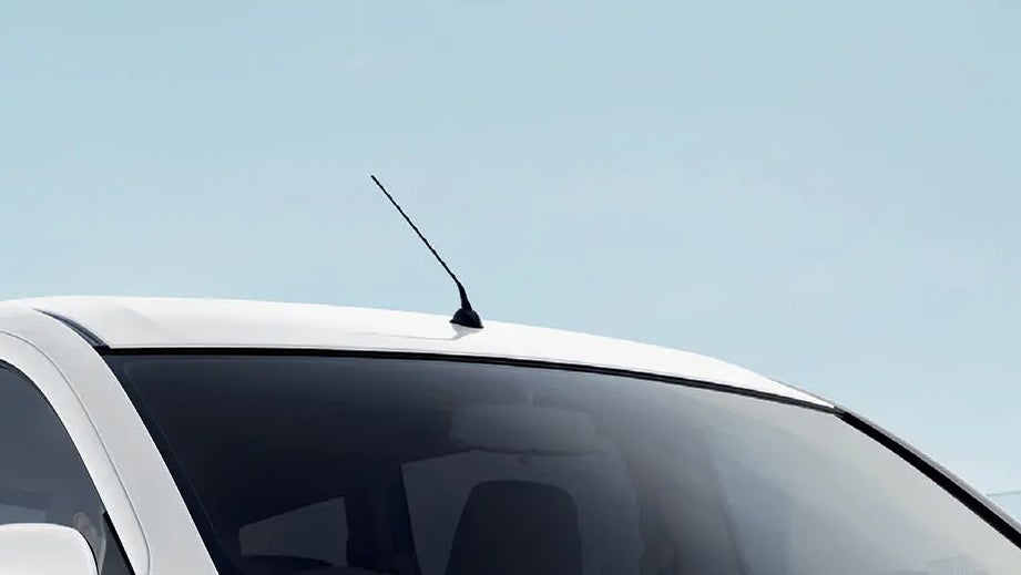 roof antenna and windshield of a Pearl Arctic White Maruti Suzuki Ertiga Tour