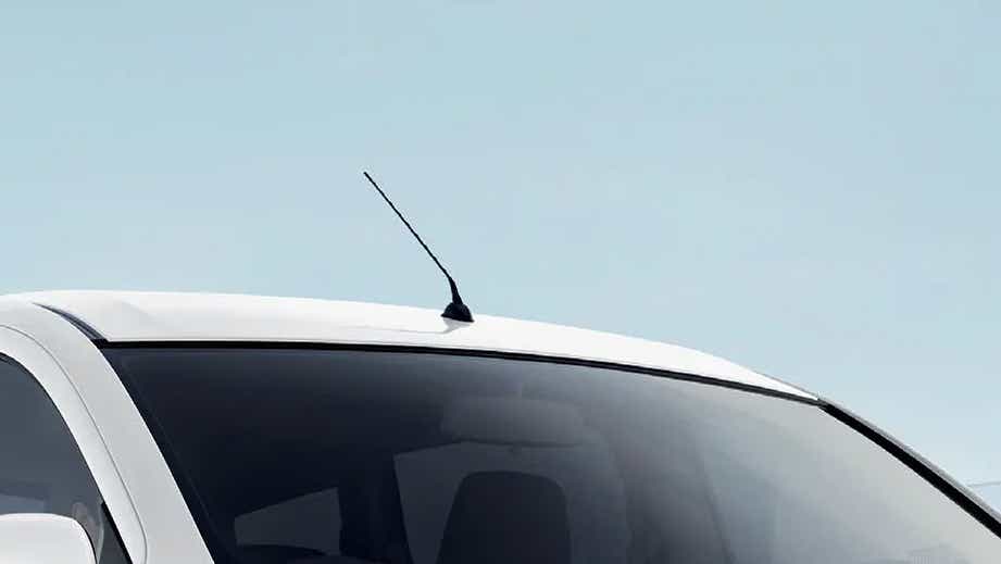roof antenna and windshield of a Pearl Arctic White Maruti Suzuki Ertiga Tour