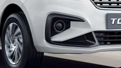 Front bumper and wheel of a Pearl Arctic White Maruti Suzuki Ertiga Tour