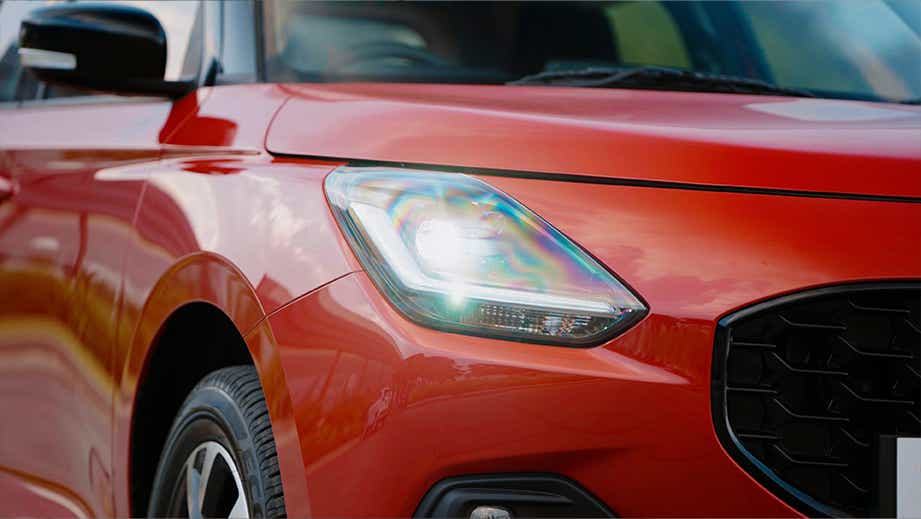 front headlight close-up of a Maruti Suzuki Swift