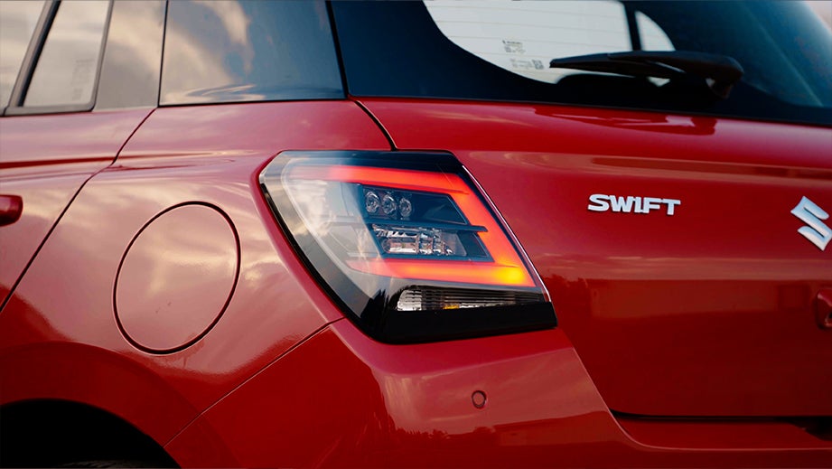 rear tail-light view of a Maruti Suzuki Swift