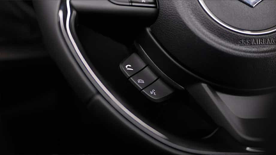 close-up of steering wheel controls of a Maruti Suzuki Swift