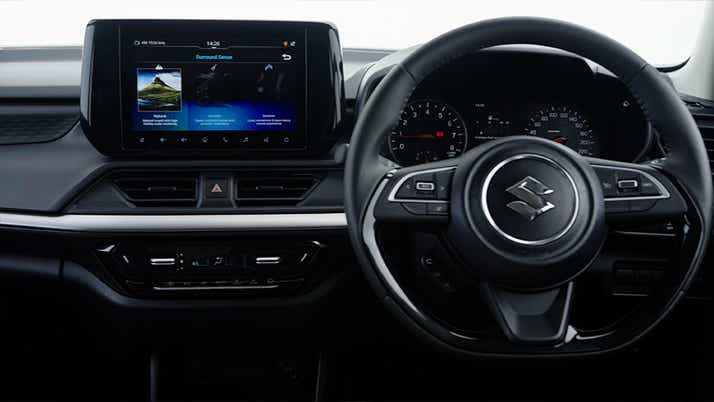 interior dashboard and steering wheel of a Maruti Suzuki Swift
