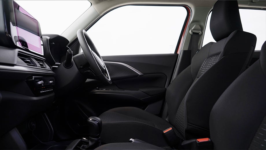Interior dashboard and front seats of a Maruti Suzuki Swift