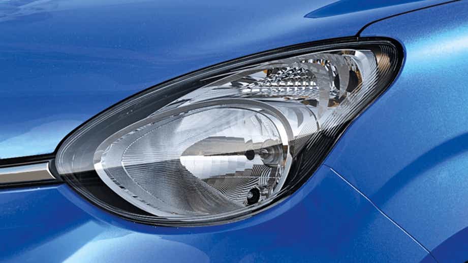 headlight close-up of a Speedy Blue Maruti Suzuki Celerio