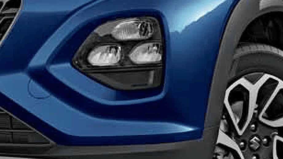 Front headlight and wheel view of a Nexa Blue Maruti Suzuki FRONX