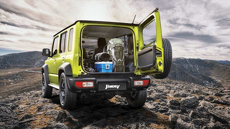 rear view of a Maruti Suzuki Jimny with open boot on rocky terrain