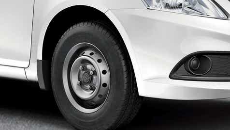 Front wheel and headlight area of a Maruti Suzuki Dzire Tour