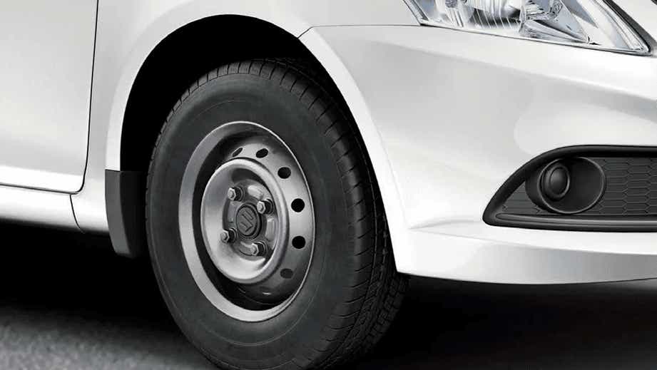 Front wheel and headlight area of a Maruti Suzuki Dzire Tour