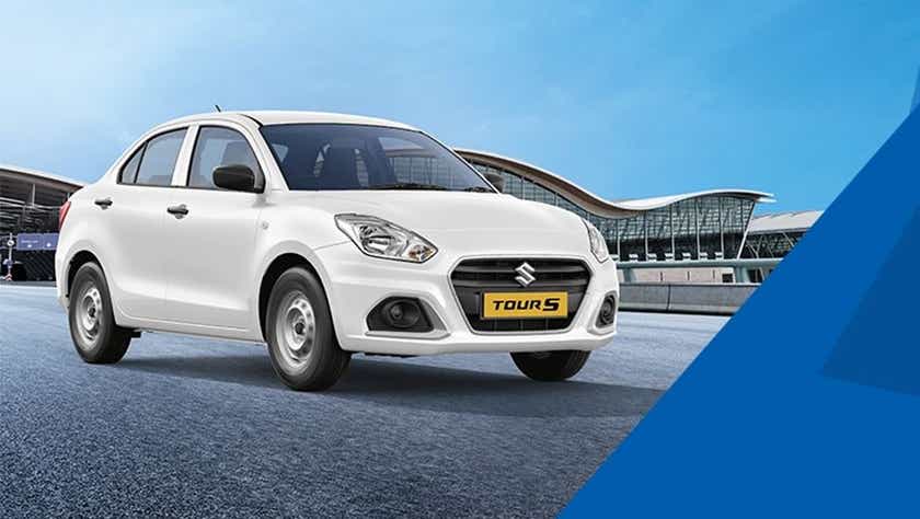 front three-quarter view of a Pearl Metallic Arctic White Maruti Suzuki Dzire Tour