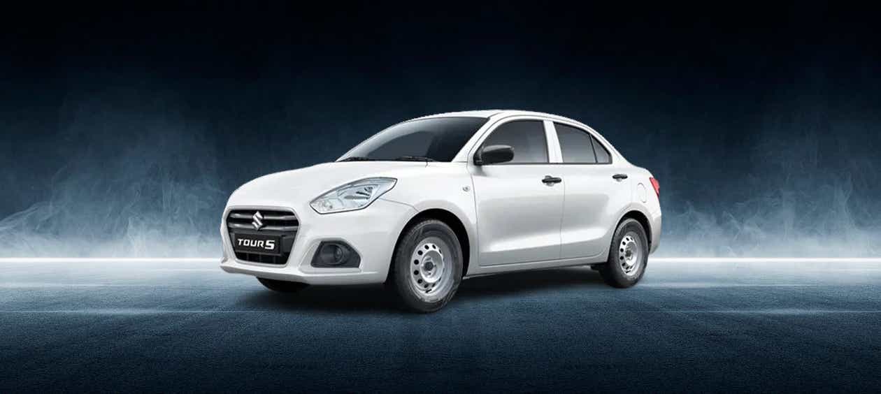 front three-quarter view of a Pearl Metallic Arctic White Maruti Suzuki Dzire Tour