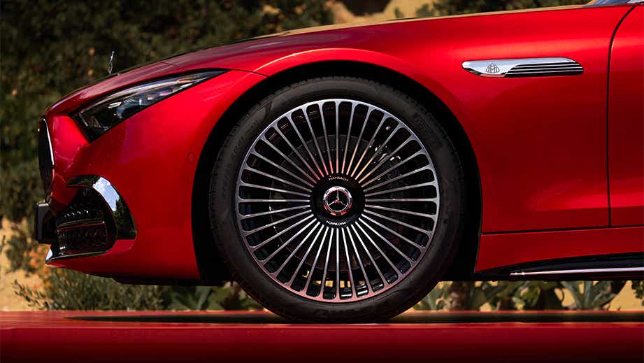 front wheel and fender view of a Garnet Red Metallic Mercedes-Benz Maybach SL 680