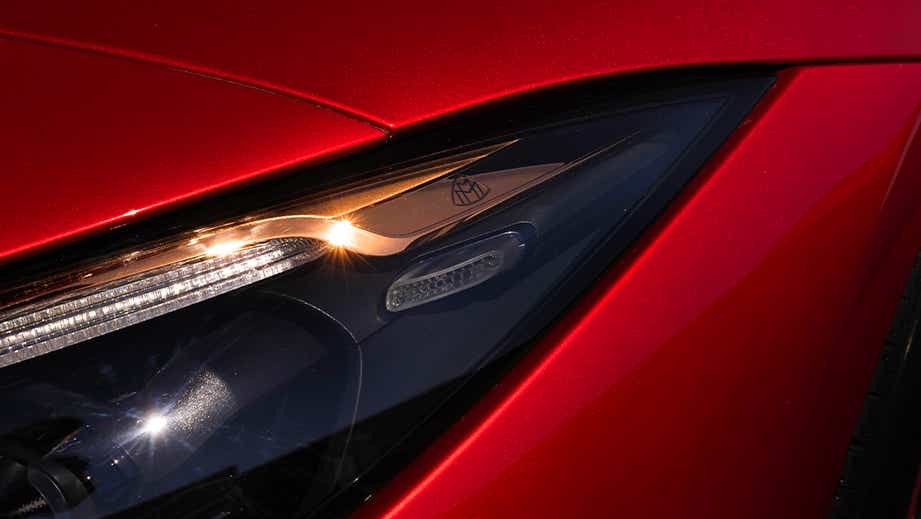Headlight close-up of a Garnet Red Metallic Mercedes-Benz Maybach SL 680
