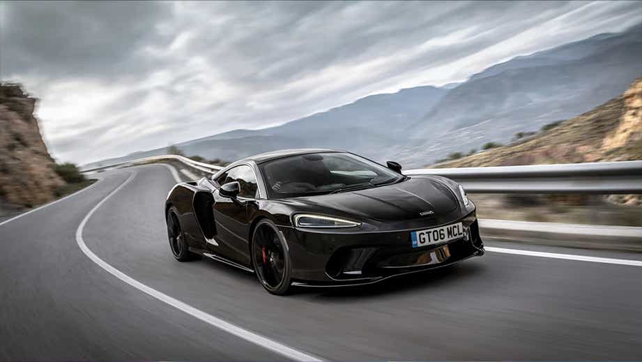 front three-quarter view of a Onyx Black Mclaren GT