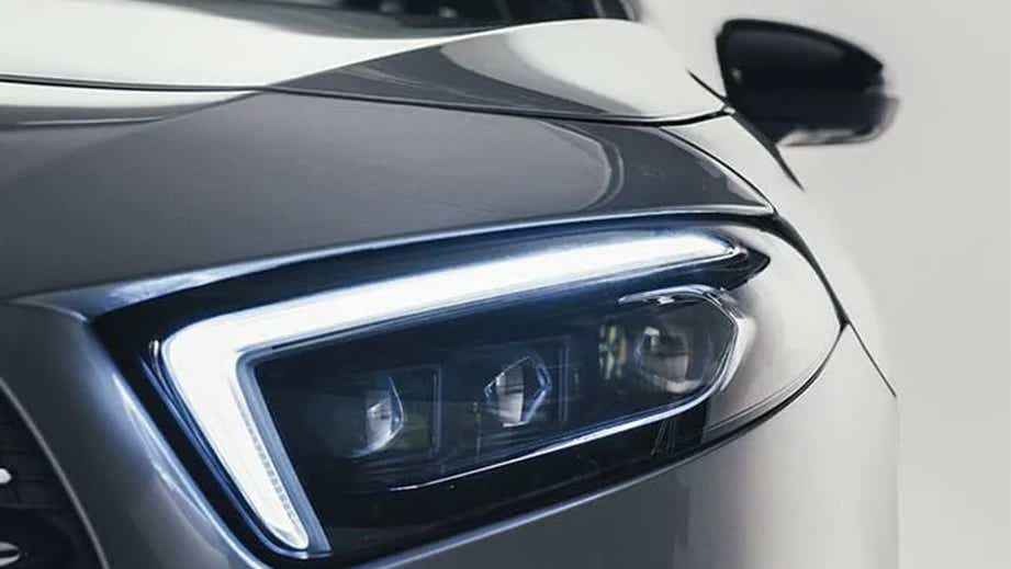 Headlight close-up of a Polar White Mercedes-Benz A-Class Limousine