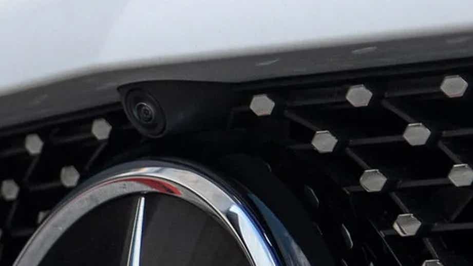 Front grille camera close-up of a Polar White Mercedes-Benz A-Class Limousine