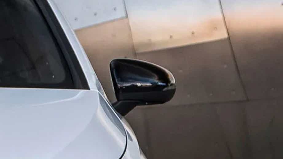 Side mirror close-up of a Polar White Mercedes-Benz A-Class Limousine