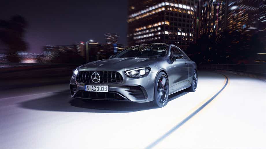 front three-quarter view of a Mercedes-Benz AMG E 53 driving at night