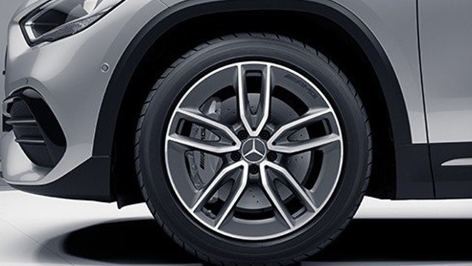 Front wheel close-up of a Polar White Mercedes-Benz AMG GLA 35