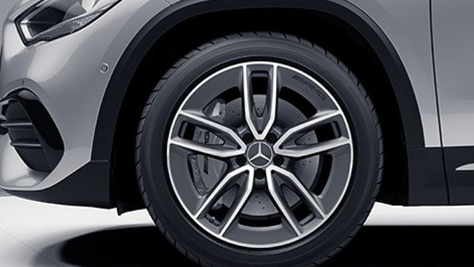 Front wheel and fender view of a Polar White Mercedes-Benz AMG GLA 35