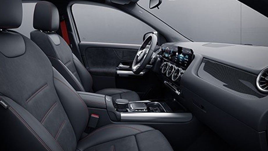 Interior front seats and dashboard of a Polar White Mercedes-Benz AMG GLA 35